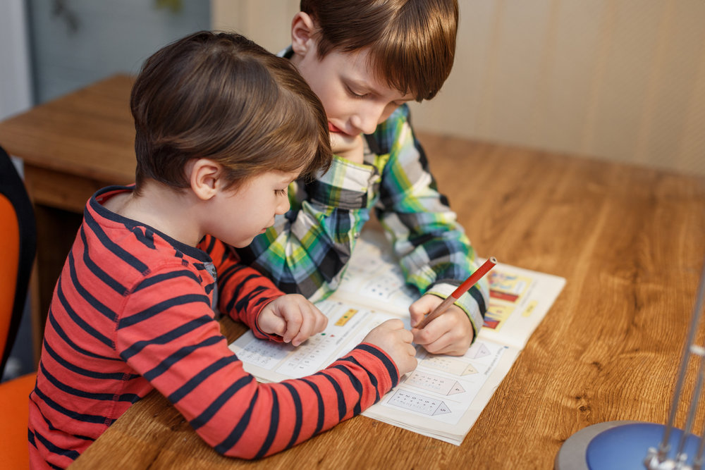 Little boys doing math homework at home, help